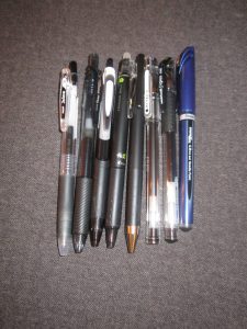 A sampler of black pens of different brands. 
