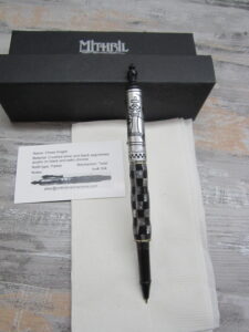 The Mistril Mechanisms Chess Knight pen - a black and silver checkerboard pen with a business card and box