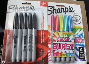 Two packages of Sharpies, one all black, one color burst