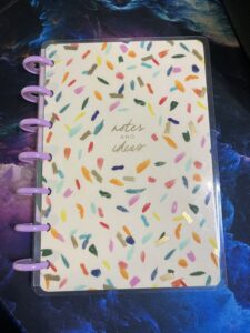 Small notes and ideas notebook with multicolored ink spots.