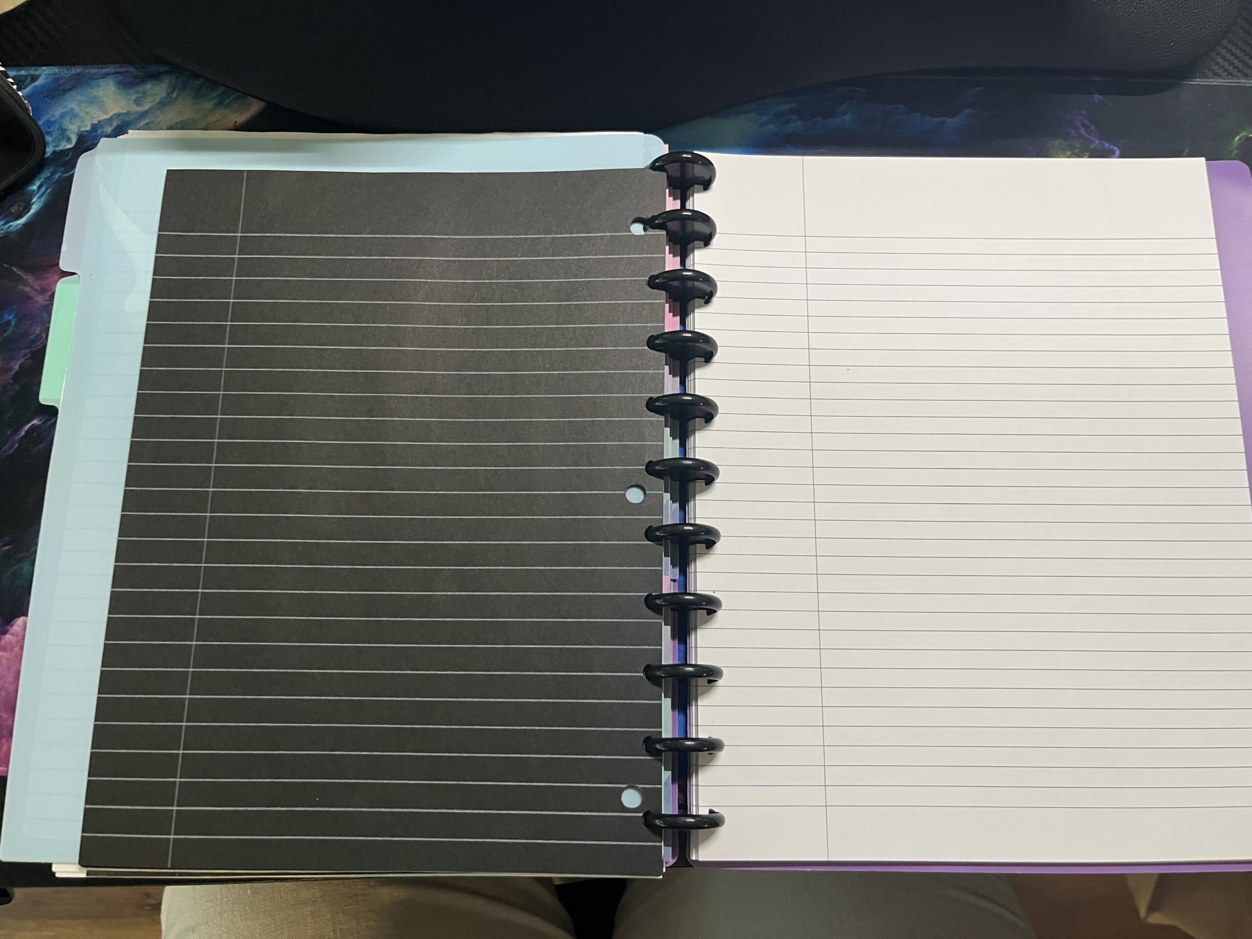 Discbound notebook with black and white paper.