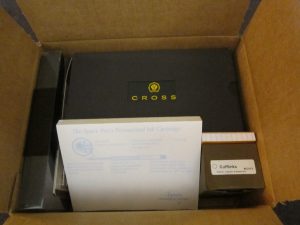 Mystery box with Cross, notepad, etc.